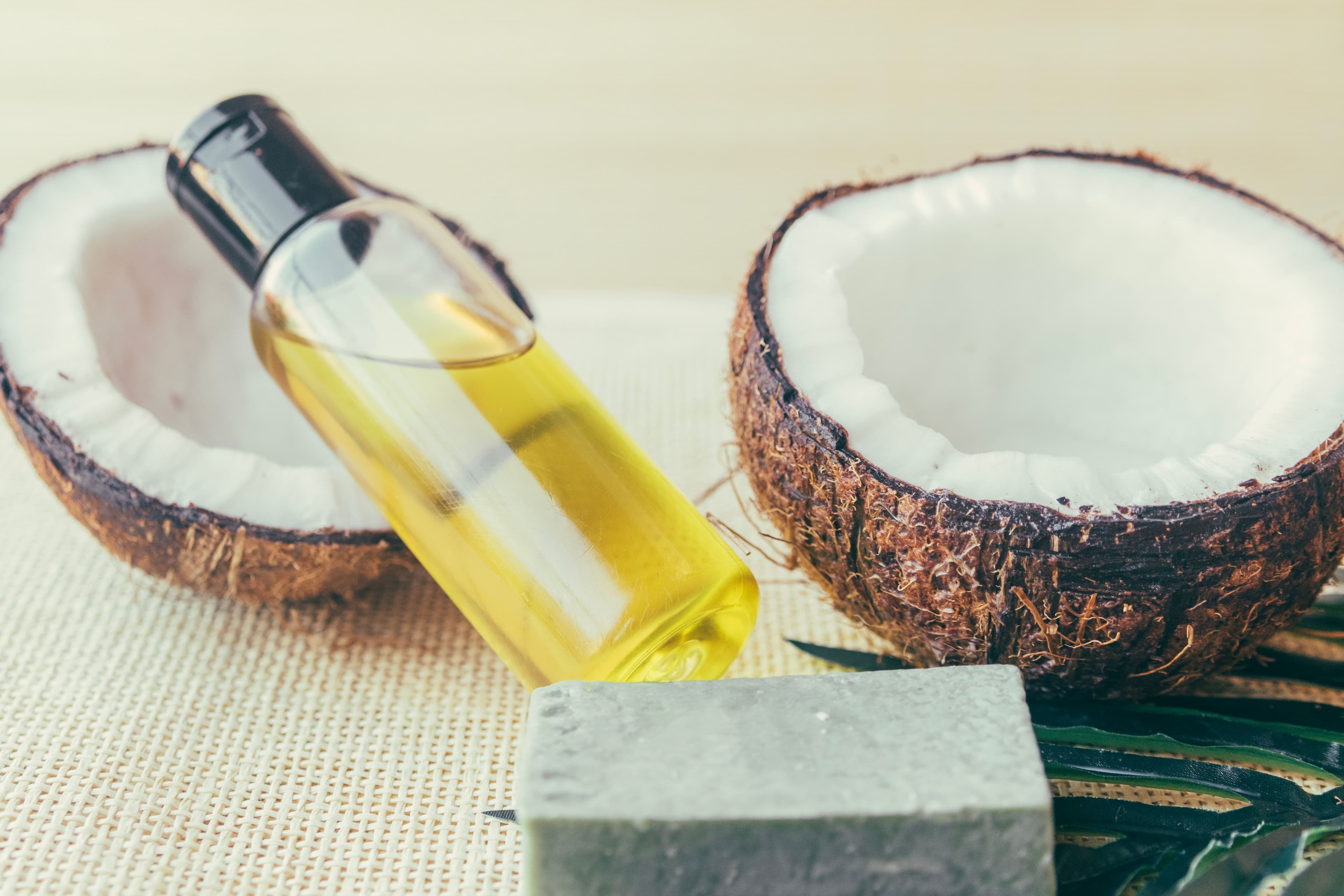 coconut with a bottle of coconut oil