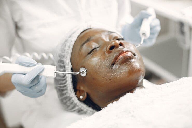 black woman getting facial treatments